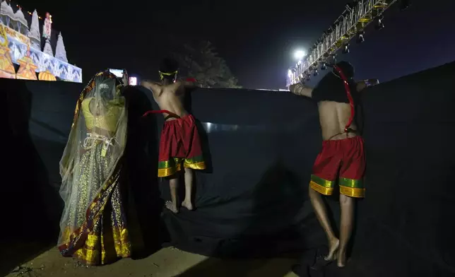 Children performing the characters of foot soldiers in Vanar Sena, or monkey brigade, wait backstage for their turn to perform in Ramleela, a dramatic folk re-enactment of the life of Hindu god Rama according to the ancient Hindu epic Ramayana, in New Delhi, India, Thursday, Oct. 10, 2024. (AP Photo/Manish Swarup)