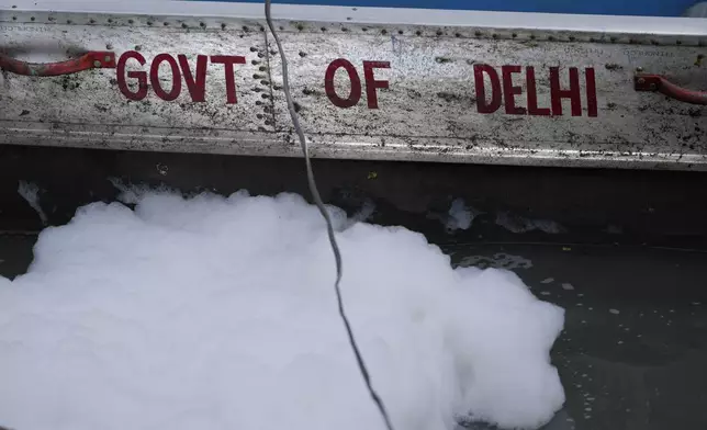 Toxic foam floats near the boat of the Delhi Jal or water board in the river Yamuna in New Delhi, India, Tuesday, Oct. 29, 2024. (AP Photo/Manish Swarup)