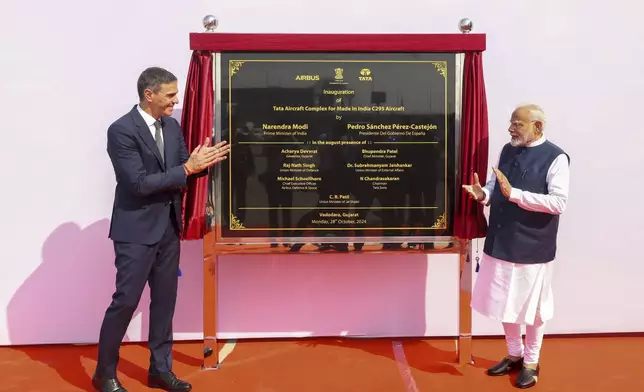 In this photo provided by the Gujarat state Press Information Bureau, Indian Prime Minister Narendra Modi, right, and his Spanish counterpart Pedro Sanchez inaugurate Tata Aircraft complex for made in India C-295 aircraft in Vadodara, India, Monday, Oct. 28, 2024. (Gujarat State Press Information Bureau via AP)