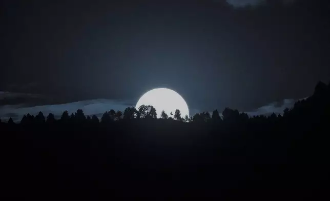 A supermoon rises behind the Zabarwan hills on the outskirts of Srinagar, Indian controlled Kashmir, Thursday, Oct. 17, 2024. (AP Photo/Mukhtar Khan)