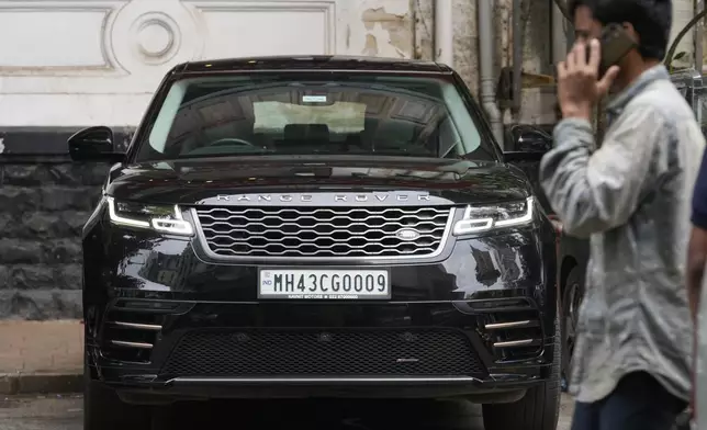 A man walks past a Tata-owned Range Rover SUV luxury car in Mumbai India, Thursday, Oct. 10, 2024. (AP Photo/Rajanish Kakade)