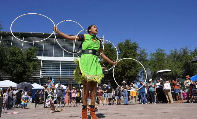 FILE - Performers from the Native American Hoop Dance of Ballet Arizona dance at an Indigenous Peoples Day festival, Oct. 9, 2023, in Phoenix. (AP Photo/Ross D. Franklin, File)