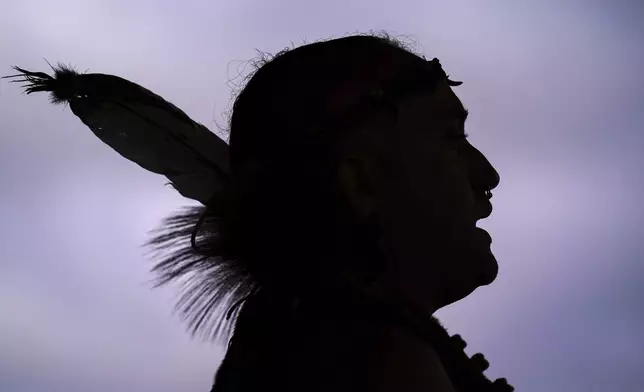 FILE - Tatanka Gibson of the Haliwa-Saponi/Nansemond Tribal Nations leads attendees in song and dance during a gathering marking Indigenous Peoples Day at Penn Treaty Park, Oct. 11, 2021, in Philadelphia. (AP Photo/Matt Rourke, File)