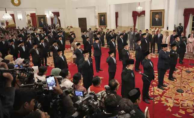 Indonesia's newly appointed cabinet ministers salute during their swearing-in ceremony at the presidential palace in Jakarta, Indonesia, Monday, Oct. 21, 2024. (AP Photo/Achmad Ibrahim)