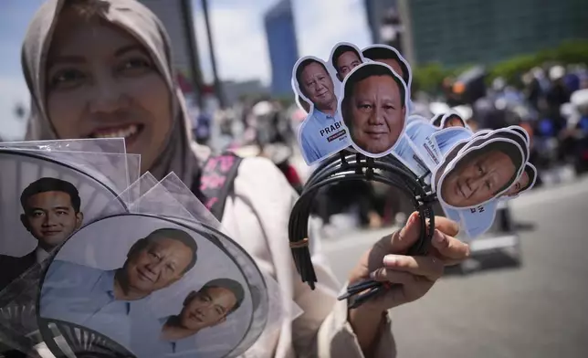 Indonesian sales souvenir with picture of Newly-inaugurated Indonesian President Prabowo Subianto in Jakarta, Indonesia, Sunday, Oct. 20, 2024. (AP Photo/Dita Alangkara)