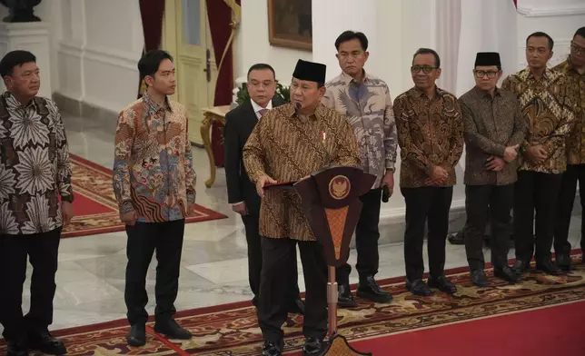 Indonesia's new President Prabowo Subianto, center, announces his cabinet lineup of newly-appointed ministers, at Merdeka Palace in Jakarta, Indonesia, Sunday, Oct. 20, 2024. (AP Photo/Achmad Ibrahim)