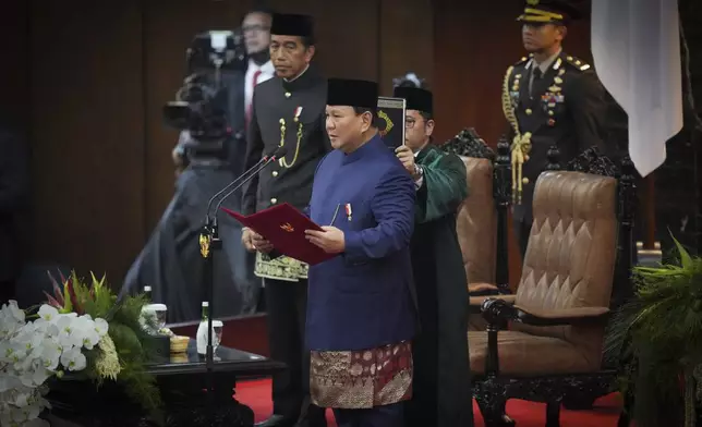 Indonesia's newly-inaugurated Indonesian President Prabowo Subianto takes the oath during the presidential inauguration ceremony at the Parliament building in Jakarta, Indonesia, Sunday, Oct. 20, 2024. (AP Photo/Tatan Syuflana)