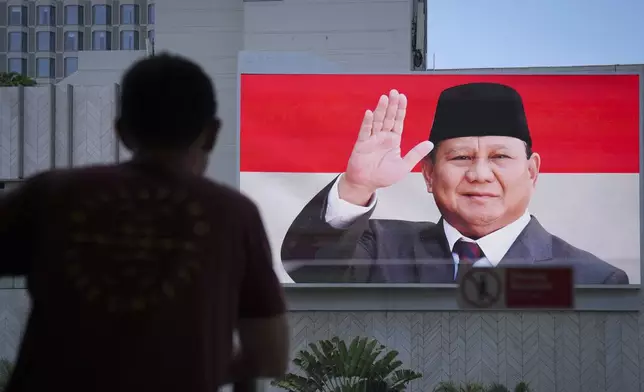 Picture of Newly-inaugurated Indonesian President Prabowo Subianto are seen on a giant screen outside a building in Jakarta, Indonesia, Sunday, Oct. 20, 2024. (AP Photo/Dita Alangkara)