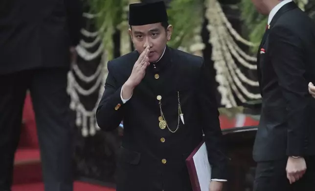 Indonesia's newly-inaugurated Vice President Gibran Rakabuming Raka, who is also the eldest son of outgoing President Joko Widodo, salutes during the presidential inauguration ceremony at the Parliament building in Jakarta, Indonesia, Sunday, Oct. 20, 2024. (AP Photo/Tatan Syuflana)