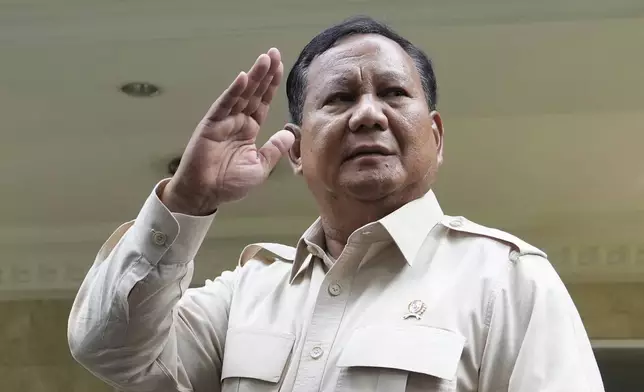 FILE - Indonesian Defense Minister Prabowo Subianto waves at journalists in Jakarta, Indonesia, Tuesday, Feb. 20, 2024. (AP Photo/Achmad Ibrahim, File)