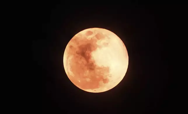 The moon rises seen from Jakarta, Indonesia, Thursday, Oct.17, 2024 .(AP Photo/Achmad Ibrahim)