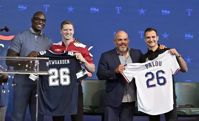 From left, former NFL player DeMarcus Ware, IndyCar driver Josef Newgarden, former baseball player Pudge Rodriguez and IndyCar driver Alex Palou pose for a group photo during a news conference announcing the IndyCar Grand Prix of Arlington to be held in 2026 in Arlington, Texas, Tuesday, Oct. 8, 2024. (AP Photo/Jerome Miron)