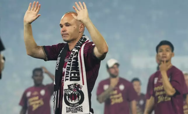 FILE - Vissel Kobe midfielder Andres Iniesta waves towards audience members at the end of a farewell ceremony to commemorate his leaving the club, after his last match with the club against Consadole Sapporo in Kobe, Japan, Saturday, July 1, 2023. Andres Iniesta who scored Spain's World Cup-winning goal in 2010 and was one of the key players who made Barcelona's tiki-taka thrive for so long, announced his retirement from soccer on Tuesday. (AP Photo/Hiro Komae, File)