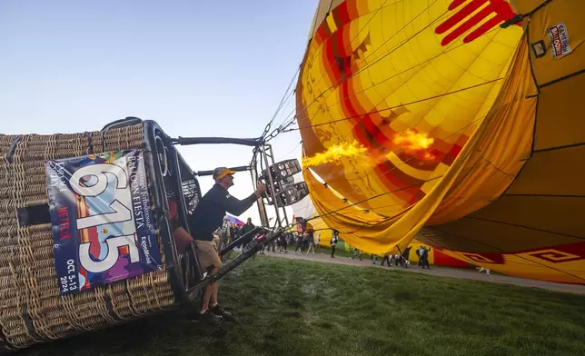 Pilot Brad Rice of Rio Rancho, N.M., prepares to take off in his balloon during the mass ascension at the 52nd Albuquerque International Fiesta in Albuquerque, N.M., on Saturday, Oct. 5, 2024. (AP Photo/Roberto E. Rosales)