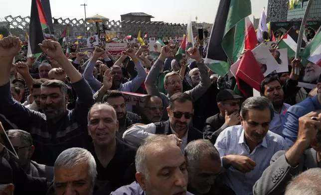 People chant slogans during the funeral ceremony of the late Iranian Revolutionary Guard Gen. Abbas Nilforushan, who was killed in an Israeli airstrike in Beirut in late September, in Tehran, Iran, Tuesday, Oct. 15, 2024. (AP Photo/Vahid Salemi)