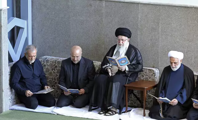 In this photo released by the official website of the office of the Iranian supreme leader, Supreme Leader Ayatollah Ali Khamenei, second right, Judiciary Chief Gholam Hossein Mohseni Ejehei, right, Parliament Speaker Mohammad Bagher Qalibaf, second left, and President Masoud Pezeshkian read Quran in a ceremony commemorating slain Hezbollah leader Hassan Nasrallah, at Imam Khomeini grand mosque in Tehran, Iran, Friday, Oct. 4, 2024. (Office of the Iranian Supreme Leader via AP)