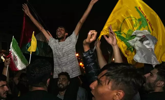 Demonstrators celebrate Iran's missile strike against Israel during a gathering in front of the British Embassy in Tehran, Iran, Tuesday, Oct. 1, 2024. (AP Photo/Vahid Salemi)