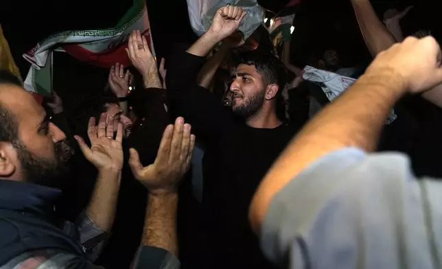 Demonstrators celebrate Iran's missile strike against Israel during an anti-Israeli gathering in front of the British Embassy in Tehran, Iran, Tuesday, Oct. 1, 2024. (AP Photo/Vahid Salemi)