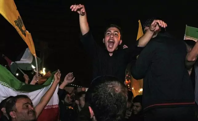 Demonstrators celebrate Iran's missile strike against Israel during a gathering in front of the British Embassy in Tehran, Iran, Tuesday, Oct. 1, 2024. (AP Photo/Vahid Salemi)