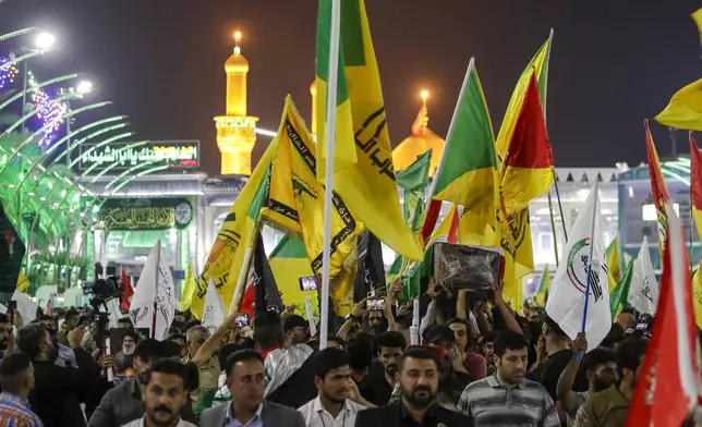 Mourners carry the coffin of Iranian Revolutionary Guards' deputy commander Brigadier Gen. Abbas Nilforushan who died alongside Hezbollah leader Hassan Nasrallah in an Israeli airstrike in Beirut last month during his funeral in Karbala, Iraq, Monday, Oct. 14, 2024. (AP Photo/Anmar Khalil)