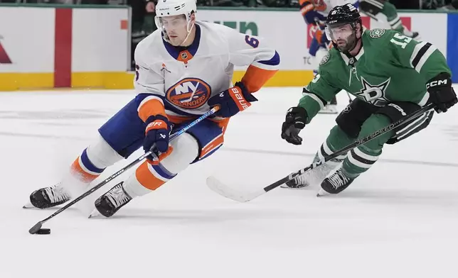 New York Islanders defenseman Ryan Pulock (6) skates with the puck against Dallas Stars center Colin Blackwell (15) during the first period of an an NHL hockey game, Saturday, Oct. 12, 2024, in Dallas. (AP Photo/LM Otero)