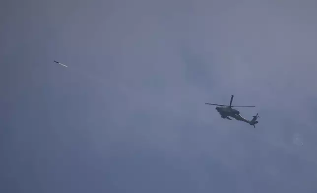 An Israeli Apache helicopter fires a missile towards southern Lebanon as seen from northern Israel, Tuesday, Oct. 1, 2024. (AP Photo/Leo Correa)