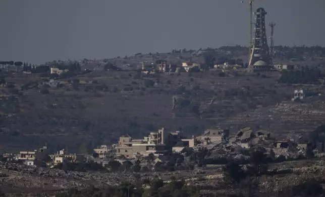 Destroyed buildings stand in an area in southern Lebanon as seen from northern Israel, Tuesday, Oct. 8, 2024. (AP Photo/Leo Correa)