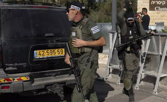 Israeli security forces secure a road near where Israel's government says a drone launched toward Israeli Prime Minister Benjamin Netanyahu's house in Caesarea, Israel Saturday, Oct. 19, 2024. (AP Photo/Ariel Schalit)