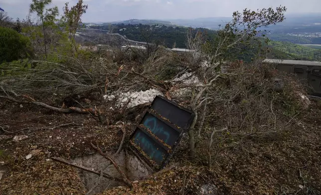 Israeli soldiers display what they say is an entrance to a Hezbollah tunnel found during their ground operation in southern Lebanon, near the border with Israel, Sunday, Oct. 13, 2024. (AP Photo/Sam McNeil)