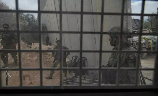 Israeli soldiers are seen during a ground operation in southern Lebanon, near the border with Israel, Sunday, Oct. 13, 2024. (AP Photo/Sam McNeil)