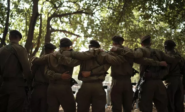 Israeli soldiers mourn Sgt. Amitai Alon, killed Sunday by a Hezbollah drone attack that wounded dozens and killed four soldiers, during his funeral near Ramot Naftali, Israel, Monday, Oct. 14, 2024. (AP Photo/Leo Correa)