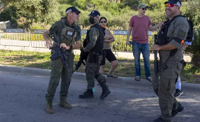Israeli security forces secure a road near where Israel's government says a drone launched toward Israeli Prime Minister Benjamin Netanyahu's house in Caesarea, Israel Saturday, Oct. 19, 2024. (AP Photo/Ariel Schalit)