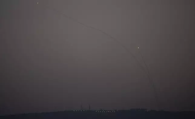 Israeli Iron Dome air defense system fires to intercept rockets that were launched from Lebanon, in northern Israel, Monday, Oct. 14, 2024. (AP Photo/Leo Correa)