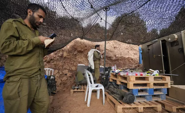 Israeli soldiers pray at a staging area in northern Israel near the Israel-Lebanon border, Tuesday, Oct. 1, 2024. (AP Photo/Baz Ratner)