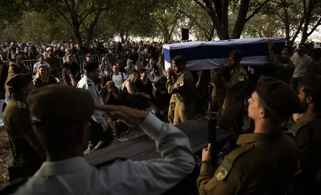 Israeli soldiers carry the flagged-covered coffin of Sgt. Amitai Alon, killed by a Hezbollah drone attack, during his funeral near Ramot Naftali, Israel, Monday, Oct. 14, 2024. (AP Photo/Leo Correa)