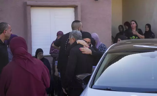 People react at the site where one person was killed after a projectile launched from Lebanon slammed into Maalot-Tarshiha, northern Israel, Tuesday, Oct. 29, 2024. (AP Photo/Ohad Zwigenberg)