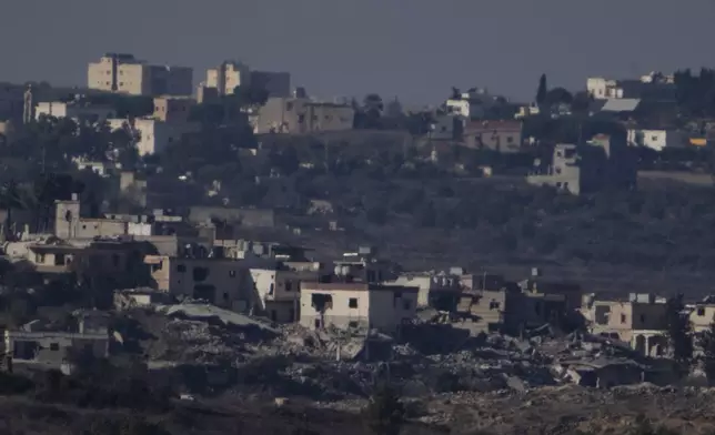 Destroyed buildings stand in an area in southern Lebanon as seen from northern Israel, Tuesday, Oct. 8, 2024. (AP Photo/Leo Correa)