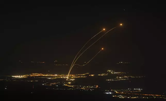 The Israeli Iron Dome air defense system fires to intercept rockets launched from Lebanon, near Kiryat Shmona, as seen from the Israeli-annexed Golan Heights, Saturday, Oct. 26, 2024. (AP Photo/Leo Correa)