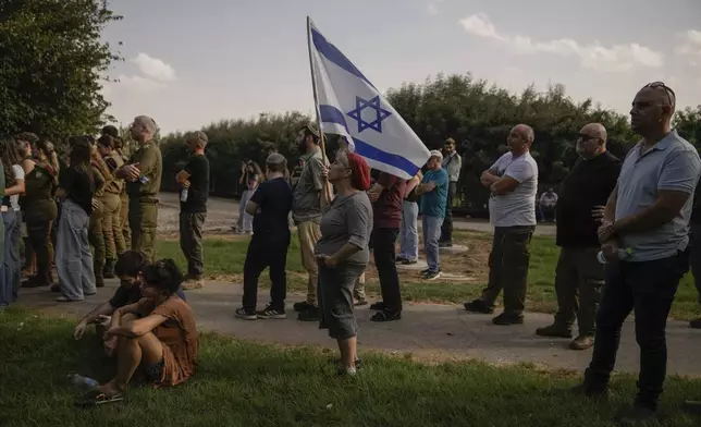 People mourn Israeli soldier Sgt. Amitai Alon, killed by a Hezbollah drone attack, during his funeral near Ramot Naftali, Israel, Monday, Oct. 14, 2024. (AP Photo/Leo Correa)