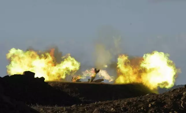 An Israeli mobile artillery unit fires a shell from northern Israel towards Lebanon, Wednesday, Oct. 2, 2024. (AP Photo/Baz Ratner)