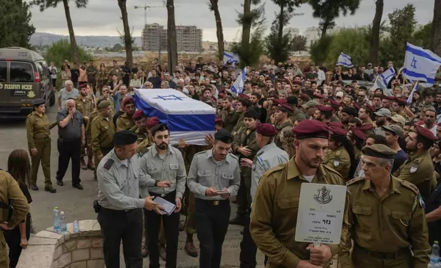 Israeli soldiers carry the flag-draped casket of Sgt. First Class Nazar Itkin, who was killed during Israel's ground operation against Hezbollah militants in Lebanon, during his funeral in Kiryat Ata, Israel, Sunday, Oct. 6, 2024. (AP Photo/Baz Ratner)