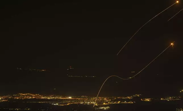 The Israeli Iron Dome air defense system fires to intercept rockets launched from Lebanon, near Kiryat Shmona, as seen from the Israeli-annexed Golan Heights, Saturday, Oct. 26, 2024. (AP Photo/Leo Correa)