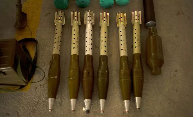 The Israeli Defense Forces display weapons seized in on a base in southern Israel, Wednesday, Oct. 9, 2024. (AP Photo/Maya Alleruzzo)