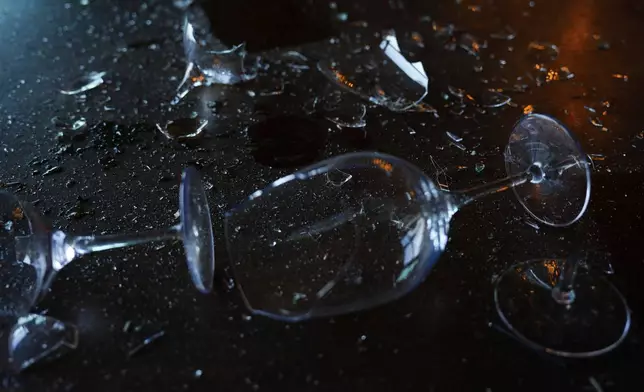 Broken wine glasses are seen in a damaged restaurant that was hit during Iran's missile attack in Tel Aviv, Israel, Wednesday, Oct. 2, 2024. (AP Photo/Ariel Schalit)