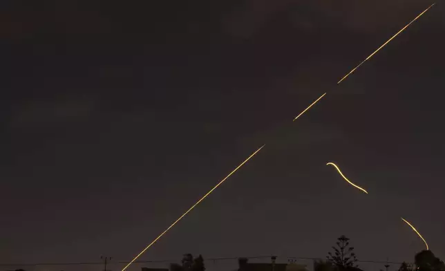 Israeli air defense system fires to intercept missiles over Hadera, Israel Tuesday, Oct. 1, 2024. (AP Photo/Ariel Schalit)