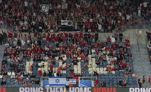 Signs calling for the return of hostages held captive by Hamas in Gaza are displayed during a match of the Hapoel Jerusalem soccer team in Jerusalem on Saturday, Sept. 21, 2024. (AP Photo/Ohad Zwigenberg)