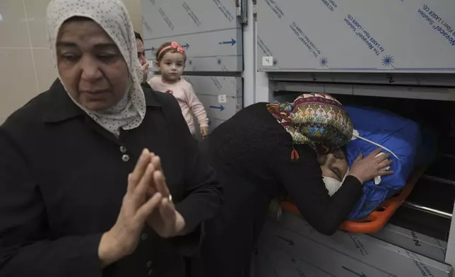 Relatives of Palestinian Husam Mallah, 28 take the last look at his body in the morgue of a local hospital, in the West Bank city of Tulkarem, Thursday, Oct. 31, 2024. (AP Photo/Nasser Nasser)