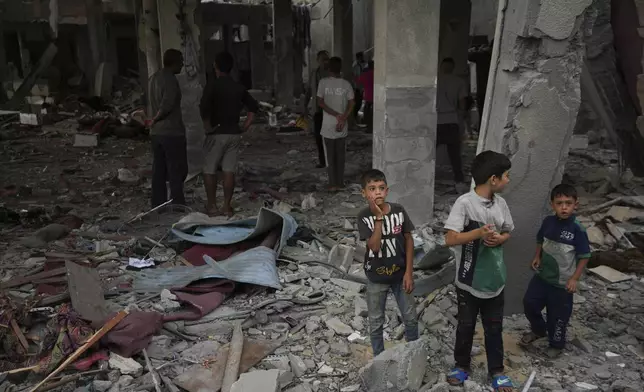 Palestinians examine a destroyed mosque following an Israeli airstrike in Deir al-Balah, Sunday, Oct. 6, 2024. (AP Photo/Abdel Kareem Hana)