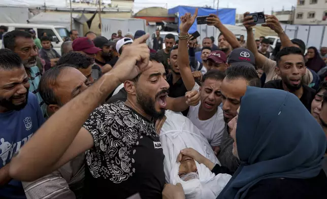 Palestinians mourn a relative killed in the Israeli bombardment of the Gaza Strip at a hospital in Deir al-Balah, Tuesday, Oct. 8, 2024. (AP Photo/Abdel Kareem Hana)