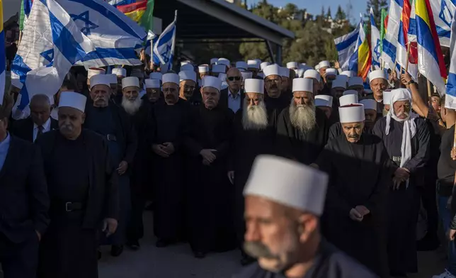 Men from the Israeli Druze minority mourn during the funeral of Israeli Colonel Ehsan Daxa in Daliyat al-Carmel, Israel, Monday, Oct. 21, 2024. Daxa, 41, was killed during Israel's ground operation in the Gaza Strip, where the Israeli army has been battling Palestinian militants in the war ignited by Hamas' Oct. 7 2023 attack into Israel. (AP Photo/Ariel Schalit)